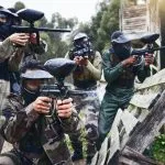 Paintball, military team and shooting training of friends and soldier group with gun. Target exercise, sport game and weapon sports of army men in camouflage together for outdoor games in uniform